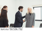 In the company meeting room Young executives are brainstorming ideas about a new business that will launch big soon. Стоковое фото, агентство Ingram Publishing / Фотобанк Лори