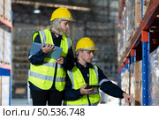 Working in a large industrial facility with heavy materials and machinery. Safety considerations are therefore of the utmost significance. Extreme vigilance must be exercised in this situation. Стоковое фото, агентство Ingram Publishing / Фотобанк Лори