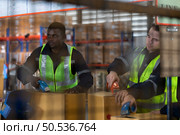 Group of worker in auto parts warehouse Packing small parts in boxes after inspecting the car parts that are ready to be sent to the car assembly plant. Стоковое фото, агентство Ingram Publishing / Фотобанк Лори