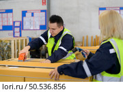 Group of worker in auto parts warehouse Packing small parts in boxes after inspecting the car parts that are ready to be sent to the car assembly plant. Стоковое фото, агентство Ingram Publishing / Фотобанк Лори