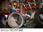 Two technicians Inspecting and testing the operation of lifting cranes in heavy industrial plants. Стоковое фото, агентство Ingram Publishing / Фотобанк Лори