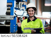 Portrait of a heavy equipment female engineer from a huge industry who came to inspect the factory’s machinery. Стоковое фото, агентство Ingram Publishing / Фотобанк Лори