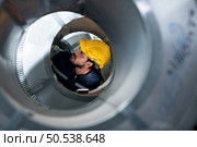 Portrait of a heavy equipment male engineer from a huge industry who came to inspect the metal sheet factory’s machinery. Стоковое фото, агентство Ingram Publishing / Фотобанк Лори