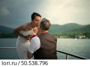 The appropriate time for a white man to propose to marry an Asian woman. on a yacht floating in the lovely water. Стоковое фото, агентство Ingram Publishing / Фотобанк Лори