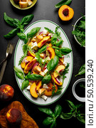Peach Panzanella salad with crusty bread, basil leaves, arugula, feta cheese and balsamic vinegar, top view. Стоковое фото, агентство Ingram Publishing / Фотобанк Лори