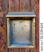 Metal box on red painted old wooden wall. Red background. Стоковое фото, агентство Ingram Publishing / Фотобанк Лори