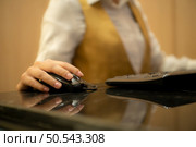 Asian ticket seller at the box office with the service of selling movie tickets to movie audiences in each round. Стоковое фото, агентство Ingram Publishing / Фотобанк Лори