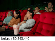 When watching scary ghost movies in theaters, moviegoers appear terrified. Стоковое фото, агентство Ingram Publishing / Фотобанк Лори