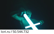 Man Swinging Two Glowing Neon Tubes. Стоковое видео, видеограф Илья Шаматура / Фотобанк Лори