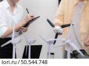 Group of multi-national team of architects and designers is meeting to brainstorm designs for wind turbines to capture wind energy and convert it into electrical energy. Стоковое фото, агентство Ingram Publishing / Фотобанк Лори