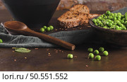 Green pea soup with linseed and pumpkin and sunflower seeds on a rustic kitchen countertop. Стоковое фото, агентство Ingram Publishing / Фотобанк Лори