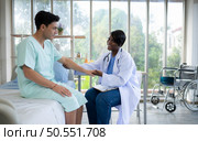 Doctor examining the patient’s arm and upper arm in hospital ward. Medical and healthcare concept. Стоковое фото, агентство Ingram Publishing / Фотобанк Лори