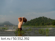 Fishermen using traditional fishing equipment After catching fish, clean up and play in the water. Стоковое фото, агентство Ingram Publishing / Фотобанк Лори