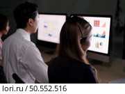 Group of broker international stock traders wearing headset working actively at night in office, Concept of customer support agent provide service on telephone. Стоковое фото, агентство Ingram Publishing / Фотобанк Лори