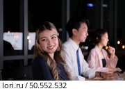 Group of broker international stock traders wearing headset working actively at night in office, Concept of customer support agent provide service on telephone. Стоковое фото, агентство Ingram Publishing / Фотобанк Лори