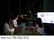 Group of broker international stock traders working actively at night in office, Everyone is striving for the team’s success. Стоковое фото, агентство Ingram Publishing / Фотобанк Лори