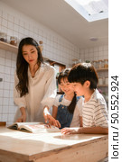 Family happy moments when children Helping mom cook food in the kitchen. Стоковое фото, агентство Ingram Publishing / Фотобанк Лори