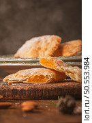 A crescent-shaped pastry whose filling is made of eggs and almonds wrapped in crispy dough, cut in an artisanal way and sprinkled with sugar. Стоковое фото, агентство Ingram Publishing / Фотобанк Лори