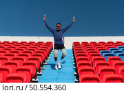 Athletes with disabilities cheer from the stands in a sports arena. Стоковое фото, агентство Ingram Publishing / Фотобанк Лори