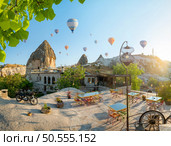 Hot air balloons flying over Cappadocia, Turkey. Balls over the hills. Стоковое фото, агентство Ingram Publishing / Фотобанк Лори