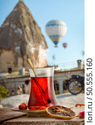 View of Cappadocia and a cup of Turkish tea. Tea and Cappadocia. Стоковое фото, агентство Ingram Publishing / Фотобанк Лори