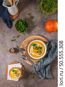 Delicious homemade creamy pumpkin soup with cream with sesame seeds and watercress. Стоковое фото, агентство Ingram Publishing / Фотобанк Лори
