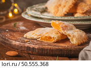 A crescent-shaped pastry whose filling is made of eggs and almonds wrapped in crispy dough, cut in an artisanal way and sprinkled with sugar. Стоковое фото, агентство Ingram Publishing / Фотобанк Лори