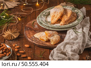 A crescent-shaped pastry whose filling is made of eggs and almonds wrapped in crispy dough, cut in an artisanal way and sprinkled with sugar. Стоковое фото, агентство Ingram Publishing / Фотобанк Лори