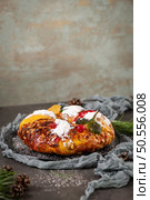 Bolo Rei or Kings Cake is a traditional Xmas cake with fruits raisins nut and icing on kitcthen countertop. Is made for Christmas, Carnavale or Mardi Gras. Стоковое фото, агентство Ingram Publishing / Фотобанк Лори
