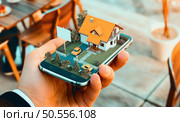 3D illustration of A futuristic architectural concept of a house projecting from a smartphone. Стоковое фото, агентство Ingram Publishing / Фотобанк Лори