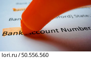 Close-up hand with yellow marker pen highlighting bank account number on the deposit money, account statement . Стоковое фото, агентство Ingram Publishing / Фотобанк Лори