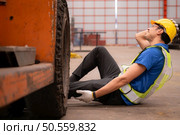 Young man working in a steel industry factory. He was critically hurt when a forklift ran over his leg and had to be transported to the hospital. Стоковое фото, агентство Ingram Publishing / Фотобанк Лори