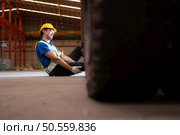 Young man working in a steel industry factory. He was critically hurt when a forklift ran over his leg and had to be transported to the hospital. Стоковое фото, агентство Ingram Publishing / Фотобанк Лори