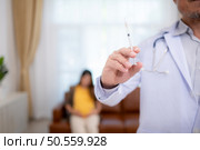 Obstetrician gynecologist and vaccination needle or pregnant woman, Asian pregnant woman visit gynecologist doctor at medical clinic for pregnancy consultant. Стоковое фото, агентство Ingram Publishing / Фотобанк Лори
