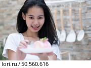 Portrait of a young asian woman with braces on her teeth. Стоковое фото, агентство Ingram Publishing / Фотобанк Лори