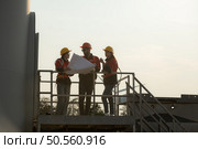 A group of engineers and architects work in floor of base ground of a wind turbine. Стоковое фото, агентство Ingram Publishing / Фотобанк Лори