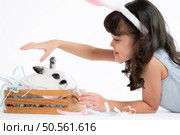 Smiling little girl and with their beloved fluffy rabbit, showcasing the beauty of friendship between humans and animals. Стоковое фото, агентство Ingram Publishing / Фотобанк Лори