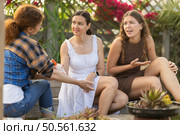 Women spray mosquito repellent on their legs and arms while working in farm and garden. Стоковое фото, фотограф Яков Филимонов / Фотобанк Лори