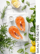 Fresh salmon steaks with herbs and ingredients for cooking, top view. Стоковое фото, агентство Ingram Publishing / Фотобанк Лори