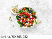Watermelon and feta cheese salad with blueberry, raspberry, pistachios and fresh greens, top view. Стоковое фото, агентство Ingram Publishing / Фотобанк Лори