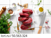 Beef. Raw beef tenderloin meat, beef steaks with ingredients for cooking. Top view. Стоковое фото, агентство Ingram Publishing / Фотобанк Лори