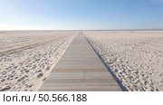 A wooden boardwalk stretches across a vast, sandy beach towards the horizon. Стоковое фото, агентство Ingram Publishing / Фотобанк Лори