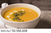 Delicious creamy homemade pumpkin soup with cream and pumpkin seed garnish. Стоковое фото, агентство Ingram Publishing / Фотобанк Лори