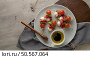 Italian style appetizer, antipasto skewer or caprese on a stick with basil, salami, mozarella and tomatoes. Стоковое фото, агентство Ingram Publishing / Фотобанк Лори