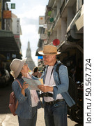 Elderly couples and their activities on the road at the end of the alley where there is a pagoda of Wat Arun, Thailand. Стоковое фото, агентство Ingram Publishing / Фотобанк Лори