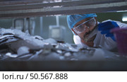 Raw material quality inspectors evaluate and inspect fish pieces before they enter the canned fish production process. Стоковое фото, агентство Ingram Publishing / Фотобанк Лори