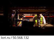 A group of warehouse employees, Inspecting products on warehouse shelves before they are sent to retailer. Стоковое фото, агентство Ingram Publishing / Фотобанк Лори