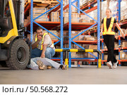 A warehouse employee suffered a leg accident at work. Стоковое фото, агентство Ingram Publishing / Фотобанк Лори