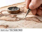 A person is writing on a map with a compass. Стоковое AI-изображение, AI-художник Ярославский Максим / Фотобанк Лори
