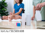A tiny child happily on the towel waiting for parents apply powder and put on clothes after taking a bath. Стоковое фото, агентство Ingram Publishing / Фотобанк Лори